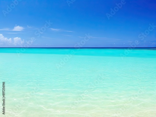 The tranquil sea water is rippled by the summer sun as it shines brightly over the seabed sand and the turquoise tropical ocean above.