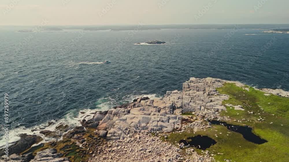 Cinematic drone shot of a lobster fishing boat cruising at sunset near the rocky shores of Nova Scotia. Perfect golden hour lighting. Canada Cinematic drone shot of a lobster fishing boat cruising at sunset near the rocky shores of Nova Scotia. Perfect golden hour lighting. Canada