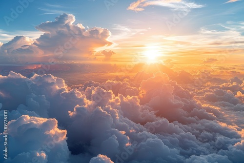Golden sunlight illuminates a vast expanse of clouds creating a breathtaking aerial view of a celestial landscape © NikahGeh