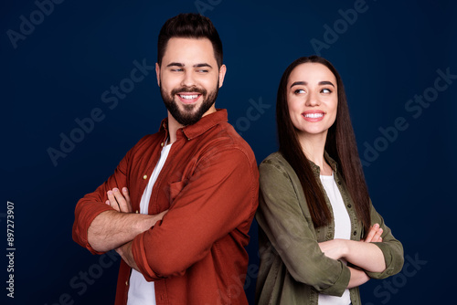 Photo of cheerful friends wife husband wear stylish clothes look each other crossed arms isolated on dark blue color background