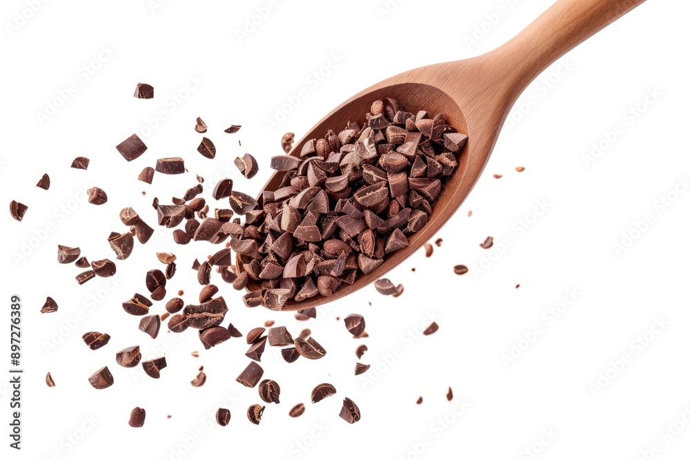 A wooden spoon filled with chocolate chips, perfect for baking or decorating A wooden spoon filled with chocolate chips, perfect for baking or decorating