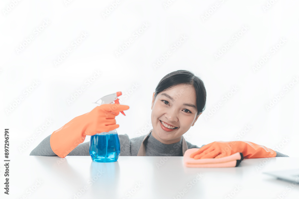 asian lady doing house chores in apron. young housewife using vacuum cleaner cleaning the wooden floor in the living room. happy housekeeper doing housework at home with attractive smile on face. asian lady doing house chores in apron. young housewife using vacuum cleaner cleaning the wooden floor in the living room. happy housekeeper doing housework at home with attractive smile on face.