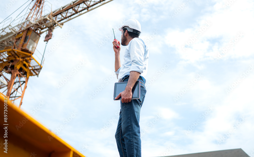 Portrait of engineer with tower crane for lift and move objects on building construction sites Portrait of engineer with tower crane for lift and move objects on building construction sites
