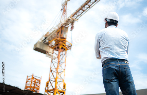 Portrait of engineer with tower crane for lift and move objects on building construction sites
