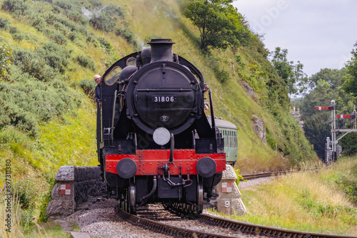Discover a captivating steam engine chugging along a scenic railway track, showcasing the nostalgia and timeless elegance of classic train travel. Perfect for historical and transportation.