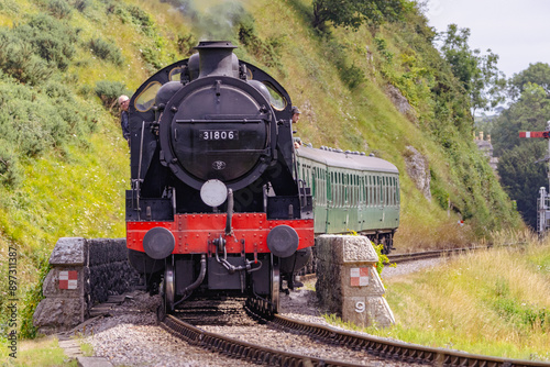 Discover a captivating steam engine chugging along a scenic railway track, showcasing the nostalgia and timeless elegance of classic train travel. Perfect for historical and transportation.