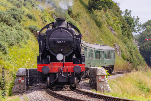 Discover a captivating steam engine chugging along a scenic railway track, showcasing the nostalgia and timeless elegance of classic train travel. Perfect for historical and transportation.
