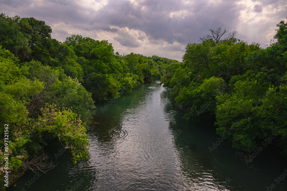 2024-06-02 THE BEAUTIFUL TREE LINED WATERWAY WITH A NICE CLOUDY SKY AT THE ZILKER PARK IN AUSTIN TEXAS 2024-06-02 THE BEAUTIFUL TREE LINED WATERWAY WITH A NICE CLOUDY SKY AT THE ZILKER PARK IN AUSTIN TEXAS