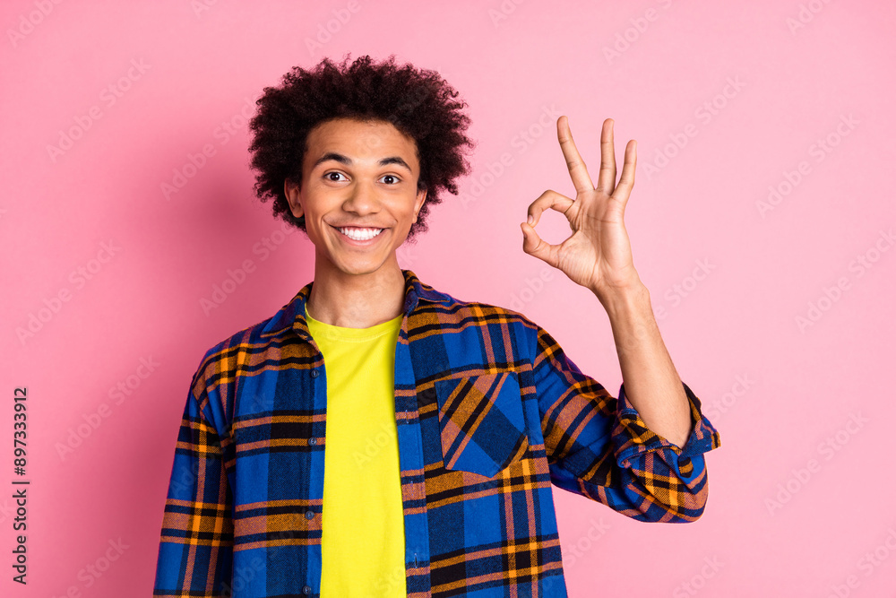 Photo of positive funny nice man wear checkered clothes okey sign isolated on pink color background