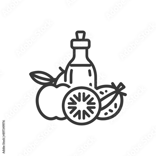 Bottle of oil with apple and orange slices