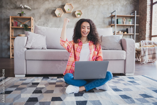 Photo of adorable lucky lady wear orange shirt winnin games modern device indoors room home house photo