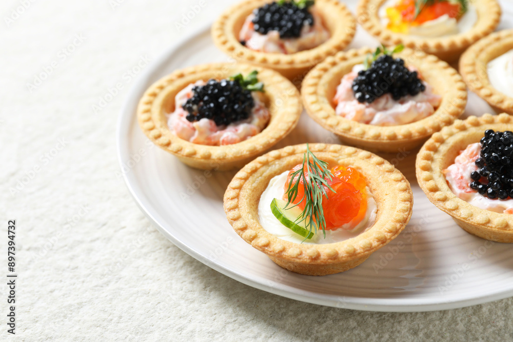 Delicious canapes with salmon and caviar on beige textured table, closeup Delicious canapes with salmon and caviar on beige textured table, closeup