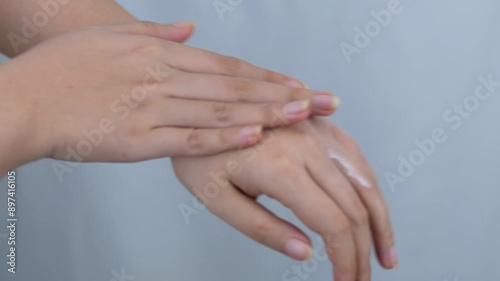 Close up of woman hand holding and applying moisturizer