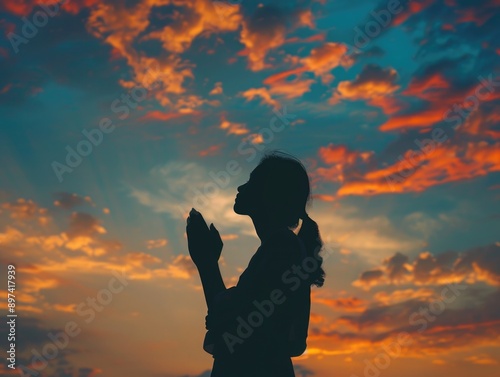 Woman Praying at Sunset Silhouette