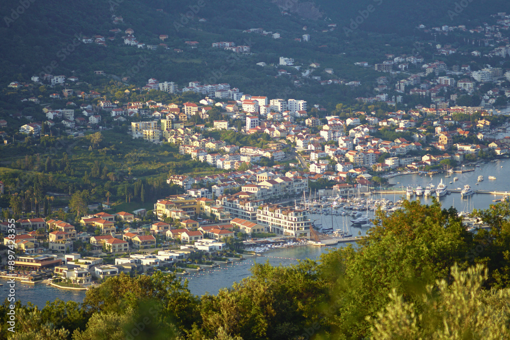 Aerial view of Kumbor and Portonovi with boat harbor (Municipality of Herceg Novi, Bay of Kotor). New development on the coast of Montenegro: view of houses, sea and greenery on a sunny summer evening Aerial view of Kumbor and Portonovi with boat harbor (Municipality of Herceg Novi, Bay of Kotor). New development on the coast of Montenegro: view of houses, sea and greenery on a sunny summer evening