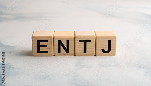 Wooden cubes with text ENTJ. Extraverted, Intuitive, Thinking, Judging. Personality type. Close-up. photo