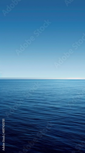 Calm ocean meets clear sky in tranquil seascape, evoking peace and freedom. Gradient of blues with copy space for message. Perfect for backgrounds or travel themes