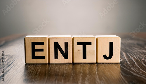 Wooden cubes with text ENTJ. Extraverted, Intuitive, Thinking, Judging. Personality type. Close-up. photo