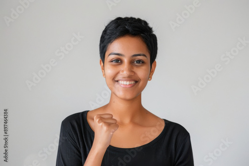 young woman short hair giving yes gesture on white background