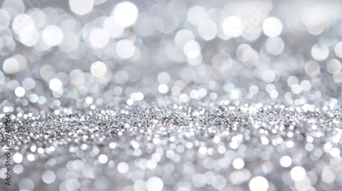 The image is a close up of a silver glittery surface with many small, round