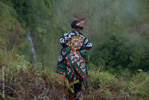 An epic performance of a traditional dance with mystical nuances performed by a dancer from one of the tribes in Indonesia. The traditional Guel dance which comes from one of the tribes in Indonesia photo
