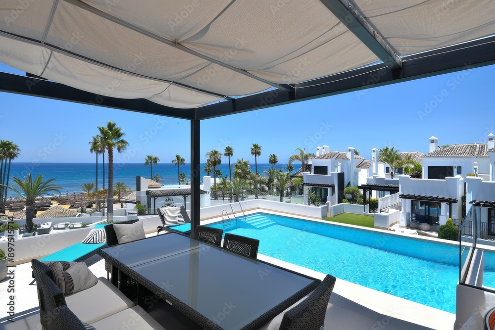 Fototapeta premium Luxurious poolside terrace with modern furniture and ocean view, creating a serene and inviting outdoor retreat.