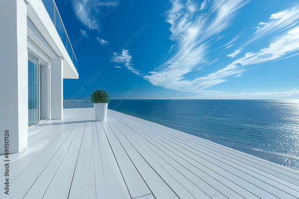 Fototapeta premium Minimalist white terrace with ocean view and clear blue sky, creating a serene and stylish outdoor space.