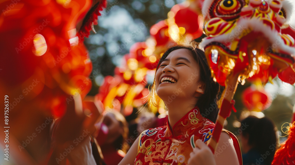 Young Asian woman in red qipao laughing under dragon dance at festival. Young Asian woman in red qipao laughing under dragon dance at festival.