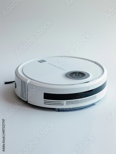 White robot vacuum cleaner sits on white surface