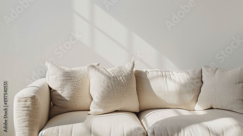 Comfortable light beige sofa close-up against a light beige wall