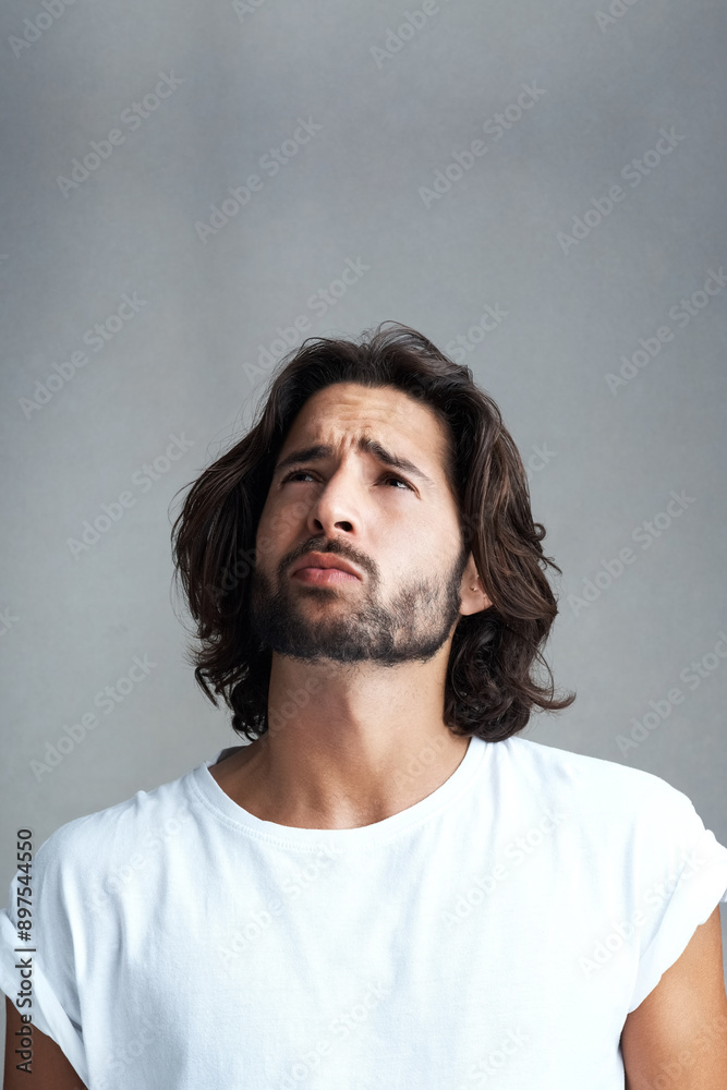 Obraz premium Thinking, question and confused man in studio for remember, decision or thoughtful on gray background. Doubtful, mockup and skeptical male model for daydream, solution or contemplating future