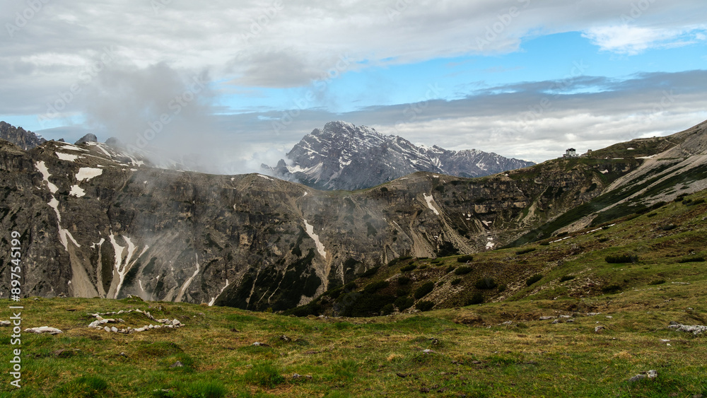 Fototapeta premium Snow and Clouds: Tre Cime Circuit in June