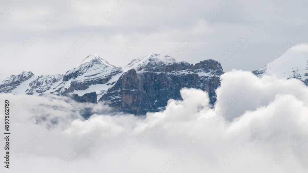 June in the Dolomites: Majestic Mountains Draped in Snow and White Clouds June in the Dolomites: Majestic Mountains Draped in Snow and White Clouds