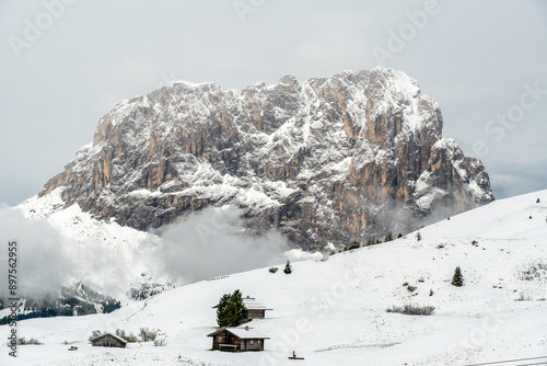 June's Whisper: Piz Culac Cloaked in Snow and Embraced by Clouds in the Dolomites photo