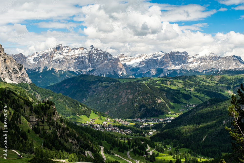 Fototapeta premium Serpentine Road through Gardena Pass: Scenic Route to Colfosco with Majestic Mountains