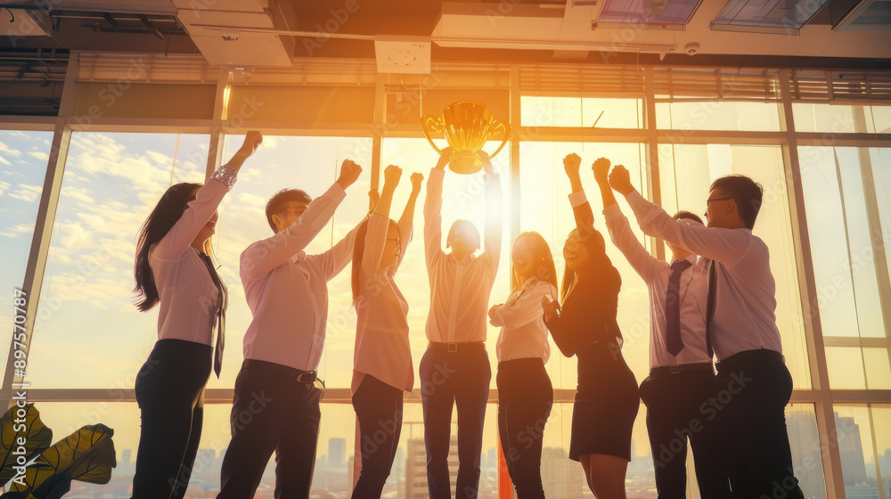 Fototapeta premium A team enthusiastically raises their fists in triumph as the sunlight pours in, celebrating success together in an urban office setting.