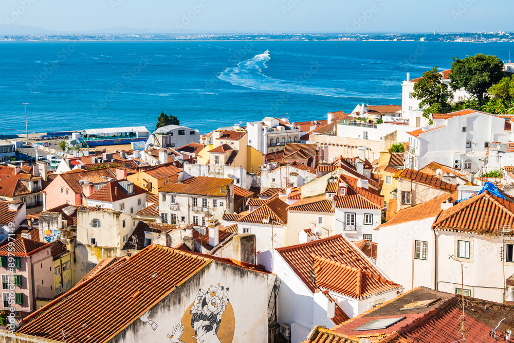 View of Lisbon old town Alfama district with houses clay orange roofs from viewpoint Portas do Sol, Lisbon, Portugal