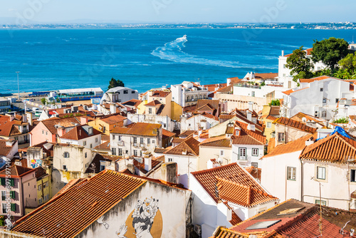 Obraz na płótnie View of Lisbon old town Alfama district with houses clay orange roofs from viewpoint Portas do Sol, Lisbon, Portugal w salonie