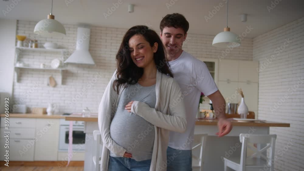 Happy funny active fooling having fun move listening music home party celebrate relocation pregnant couple dance pregnancy medical insurance health dancing man guy male father woman girl female mother