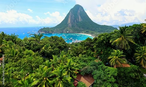 Downtown Soufriere, Saint Lucia with famous Petit Piton mountain in background. Aerial reveal of colorful town and tourist attracting landscape 4k video