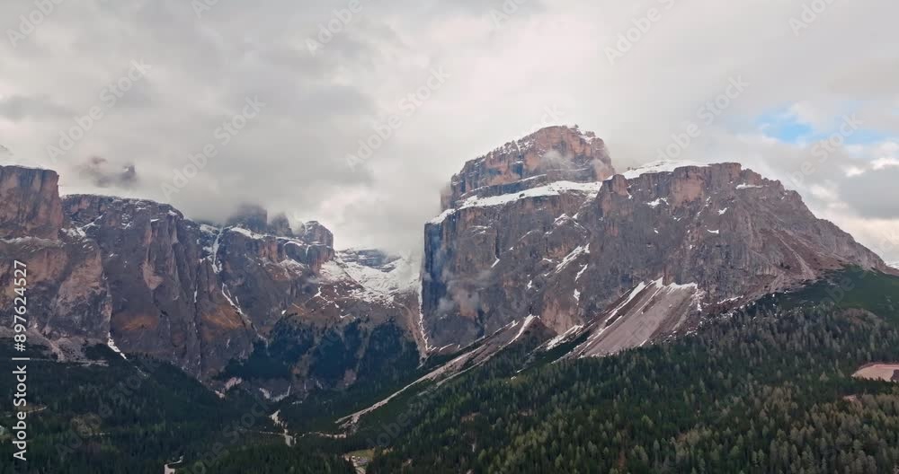 Explore the Dolomite Alps: Aerial Views of Beautiful Pine Forests and Snowy Mountain Ranges in Italy's Nature Landscape. High quality 4k footage