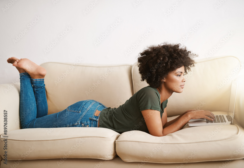 Black woman, laptop and relax on couch for reading ebook, streaming movies and weekend peace in home. African lady, computer and rest on sofa for social media post, watch documentary and blog update Black woman, laptop and relax on couch for reading ebook, streaming movies and weekend peace in home. African lady, computer and rest on sofa for social media post, watch documentary and blog update