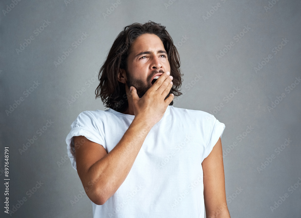 Tired, yawn and man in studio with fatigue, burnout and exhausted from no sleep on gray background. Insomnia, emoji and isolated person with gesture for lazy, bored and low energy for nap or rest Tired, yawn and man in studio with fatigue, burnout and exhausted from no sleep on gray background. Insomnia, emoji and isolated person with gesture for lazy, bored and low energy for nap or rest