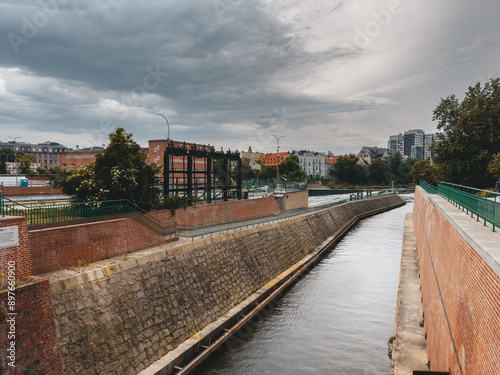 Wallpaper Mural Riverside scene in Wroclaw, Poland, showcasing a mix of historical and modern architecture along the waterfront. Torontodigital.ca