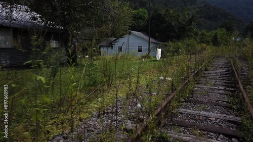 Houses and streets in the abandoned coal mining town with a railroad through the middle of it in southern West Virginia. photo