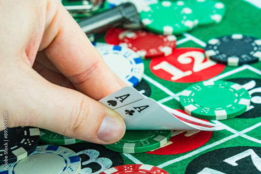 Obraz premium Poker cards with win combination. The player hand holds a winning combination in a game in a poker The concept of luck in the poker game. A winning combination in poker is two aces on a table of chips