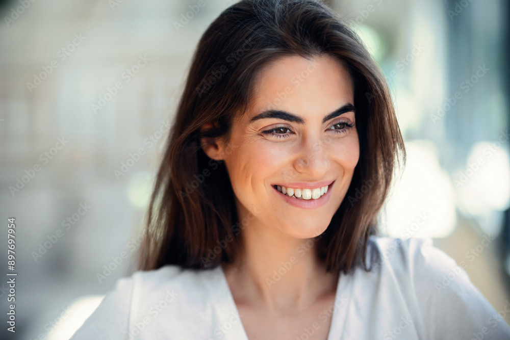 Portrait of smiling young woman posing while looking at camera in the living room at home. Portrait of smiling young woman posing while looking at camera in the living room at home.