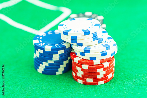 Dice with a winning combination in poker on a black table and chips in the background. Poker Chips on a gaming table