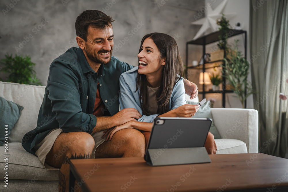 Adult caucasian couple buy online on digital tablet with credit card