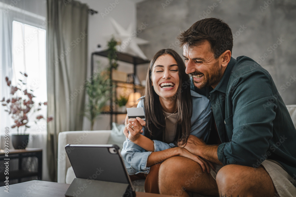 Couple hug each other after online shopping on digital tablet Couple hug each other after online shopping on digital tablet
